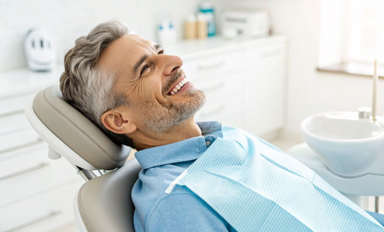 Smiling patient after receiving best tooth filling types