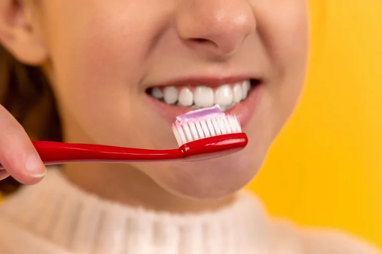 A picture of a woman brushing her teeth