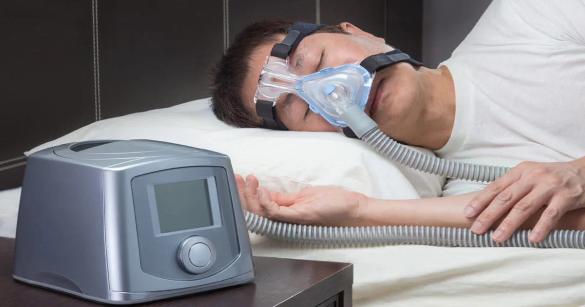 A picture of a person sleeping with a CPAP
